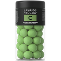 Jar of green chocolate-coated sweets with 'Lakrids by Bülow' label on a white background